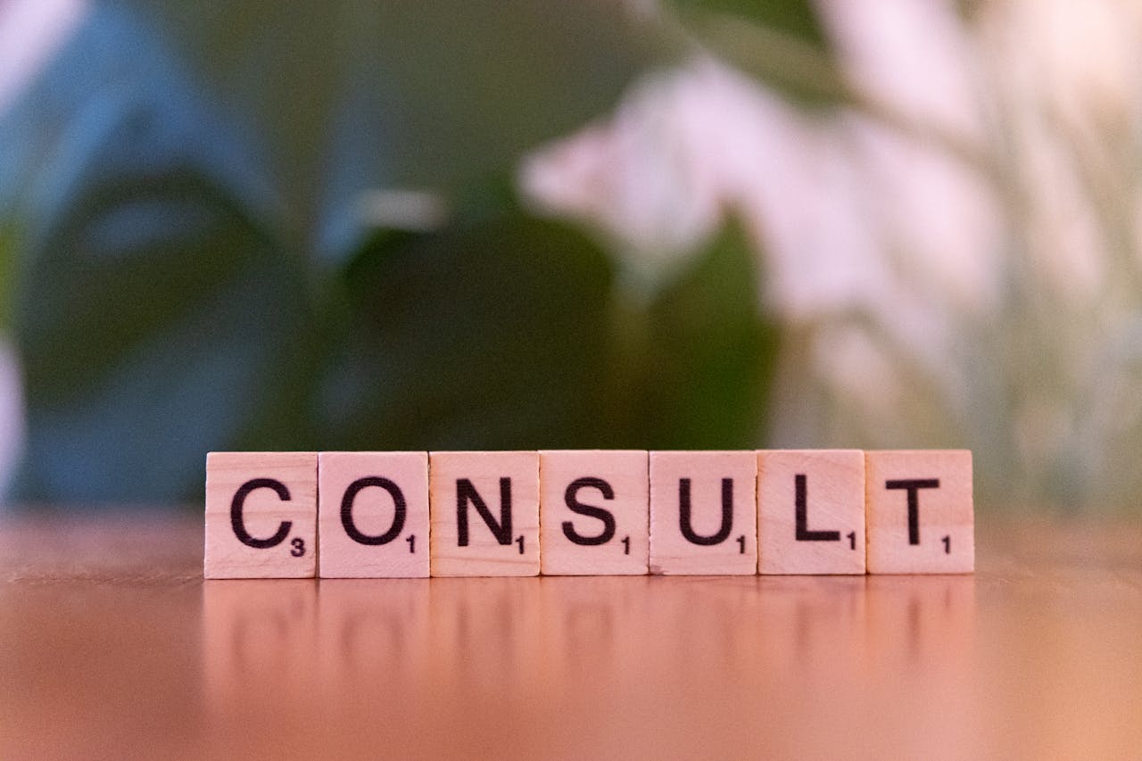 Mastering the First Impression: Your intriguing post title goes here Scrabble tiles spelling 'CONSULT' on a wooden table with blurred background.